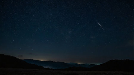 Night starry sky with milky way and stars over the mountainsの写真素材