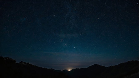 Milky way over the mountains at night with starry sky.の写真素材