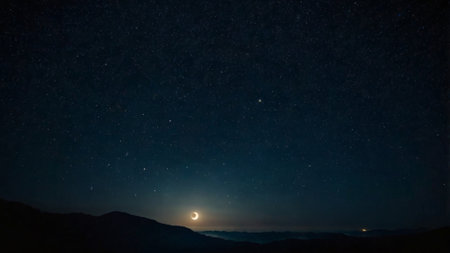 Night sky with stars and milky way. The moon over the mountains.の写真素材