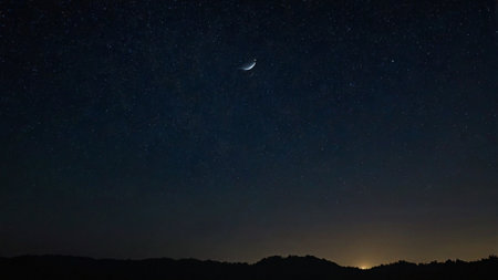 Night sky with stars and moon. Milky way over the mountains.の写真素材