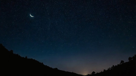 Night starry sky with milky way and moon. Long exposure photograph.の写真素材
