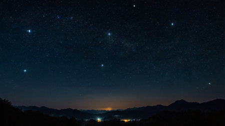 Milky way and stars in the night sky with silhouette of mountainsの写真素材