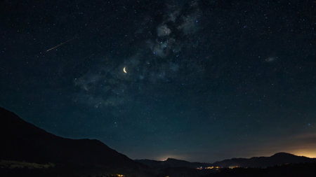 Milky way over the mountains with stars and moon in the sky