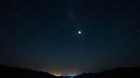 Night sky with stars and the moon. The starry sky over the mountains.