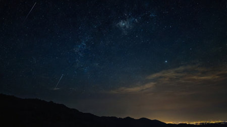 Milky way over the mountains. Night sky with stars and galaxies