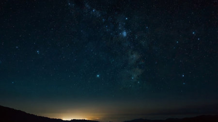 Milky way over the mountains at night. Panoramic view.