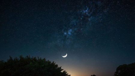 The moon in the night sky with stars and milky way.