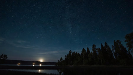 Night landscape with milky way, forest and lake. Long exposure photograph.の写真素材