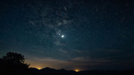 Night sky with stars and milky way over the mountains. Long exposure.の写真素材