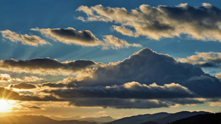 Sunset over the mountains. Beautiful sky with clouds at sunset.の写真素材