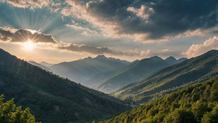 Mountain landscape with sun shining through the clouds. Beautiful summer panoramaの写真素材
