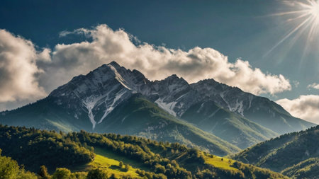 Mountain landscape with snow-capped peaks in the clouds.の写真素材