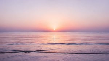 Blur image of sunset on the beach with bokeh background.