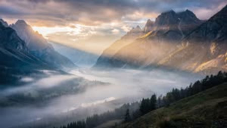 Beautiful panoramic view of foggy valley in the mountains.