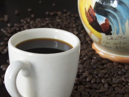 Freshly Brewed Coffee in a white mug  Cookie jar in background  Displayed on dark table top の写真素材
