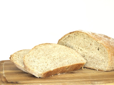 Delicious freshly baked loaf of bread. Displayed on a cutting board. の写真素材