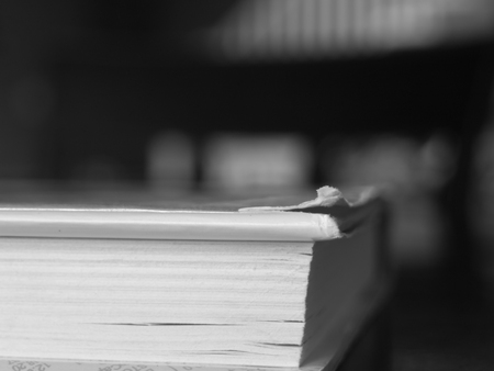 A book with a torn corner, sitting on a table.の写真素材