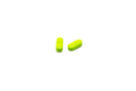 Green pills isolated on a white background