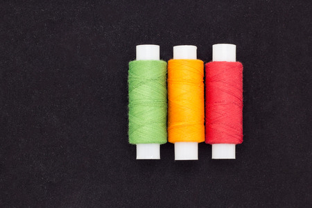 Colored threads on black velvet