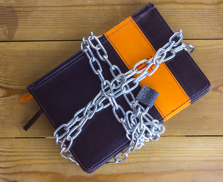 Diary wrapped in a silver chain with a lockの写真素材