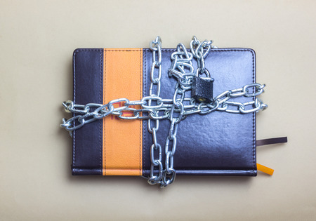 Diary wrapped in a silver chain with a lockの写真素材