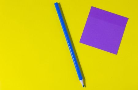 Pencil on yellow background with stickers and signsの写真素材