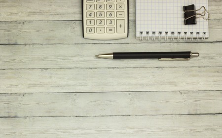 Top view office table calculator with pen on the table for business and copy space.の写真素材