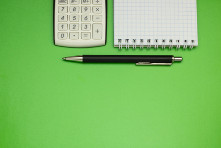 Top view office table calculator with pen on the table for business and copy space.の写真素材