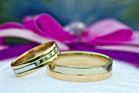 Two gold wedding rings of white and yellow goldの写真素材