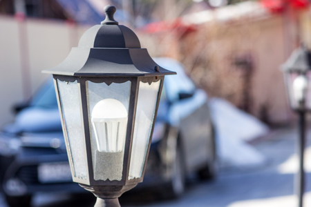 Antique street lamp in the street parking, in the background carの写真素材