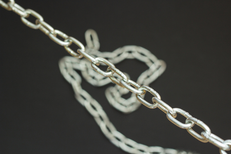 Silver chain on black background, concept strong loveの写真素材