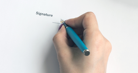 A person signs an important document or decision, close-upの写真素材