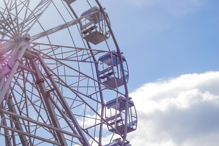 part of a ferris wheel against a blue skyの写真素材