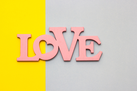 Wooden word "love" on a multicolored background, top viewの写真素材