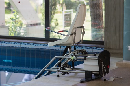 chair lift device for disabled people in close swimming pool