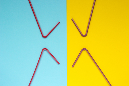 multicolored curved straw on a blue and yellow backgroundの写真素材