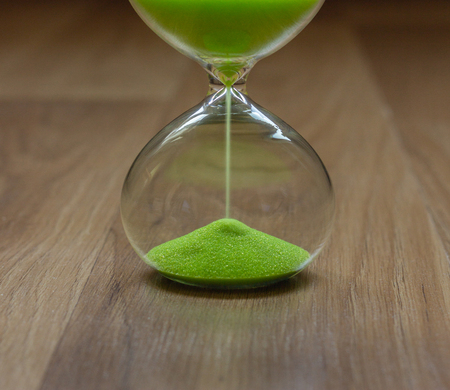 Close-up, hourglass on a wooden table, lower partの写真素材