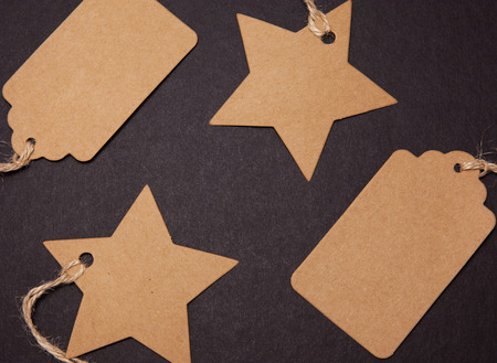 Close-up, price tags in the shape of a star and a rectangle on a black backgroundの写真素材