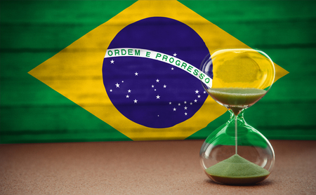 Hourglass on the background of the Brazilian flag, the concept of time and countries, space for textの写真素材