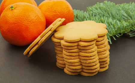 Mandarins - Christmas fruits and ginger cookies on a dark background.の写真素材