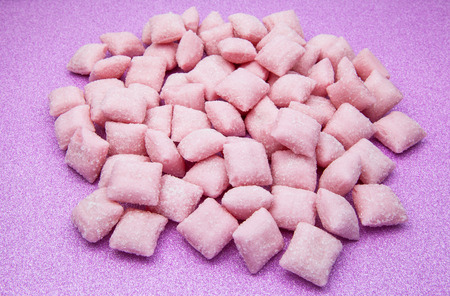 Sweet candy pads mixed on pink backgroundの写真素材