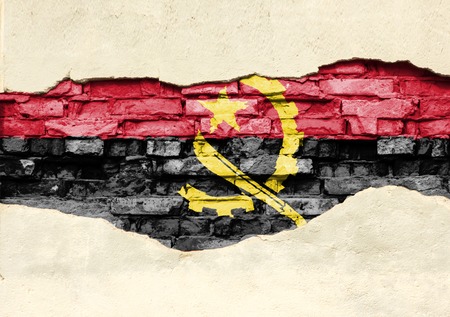 National flag of Angola on a brick background. Brick wall with partially destroyed plaster, background or texture.の写真素材