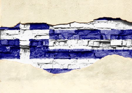National flag of Greece on a brick background. Brick wall with partially destroyed plaster, background or texture.の写真素材