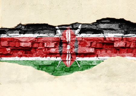 National flag of Kenya on a brick background. Brick wall with partially destroyed plaster, background or texture.の写真素材