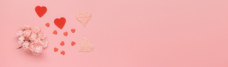 Flowers composition. Pattern made of pink flowers and hearts on pink background. Flat lay, top view, space for textの写真素材