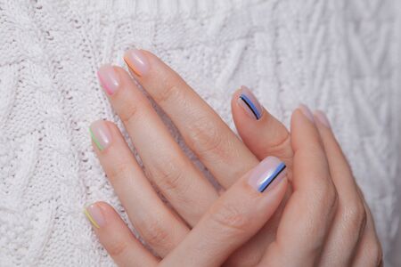 Nail polish. Art manicure. Modern style multi-collored nail polish. Stylish pastel color colored...