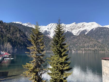 View of a beautiful lake and mountains with fir trees