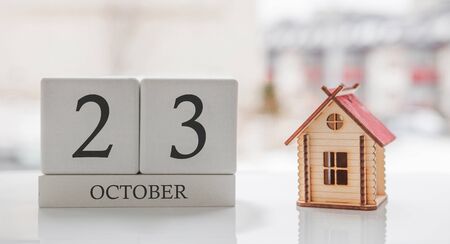 October calendar and toy home. Day 23 of month. Card message for print or rememberの写真素材