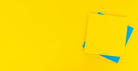 Colored paper stickers on a yellow background, space for text, ad unitの写真素材