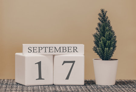 Desk calendar for use in different ideas. Autumn month - September and the number on the cubes 17. Calendar of holidays on a beige solid background.の写真素材